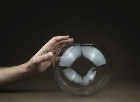 one hand over transparent glass ball. High quality photo