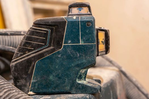 Professional laser level. Renovation and construction of houses and apartments, the concept of redevelopment. Professional tool.