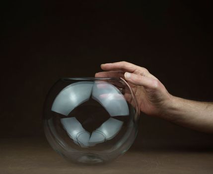 one hand over transparent glass ball. High quality photo