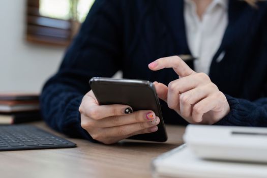 Business woman hand holding cell phone with bank savings account application, account or saving money or insurance concept.