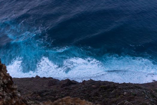 ocean surf waves at sunset view from above. High quality photo