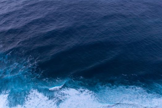 ocean surf waves at sunset view from above. High quality photo