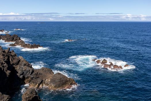 stormy ocean big breaking waves and sharp cliffs. High quality photo