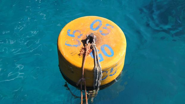 summer, sea, in transparent bluish water floats orange buoy. High quality photo