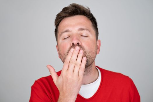 Handsome male blows air kiss, expresses his devotion and truthful love to girlfriend . People, body language and facial expressions concept. 