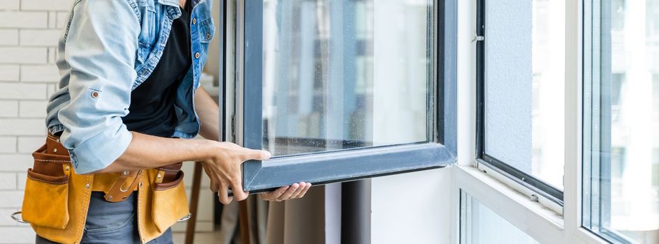 Construction Worker Installing New Windows In House.