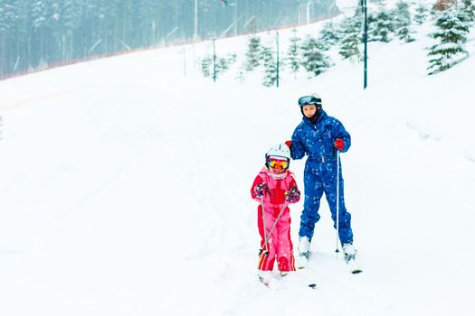 Image of sporty family spending time on winter resort during vacations