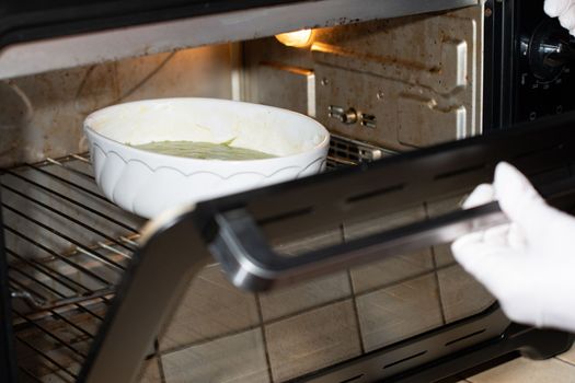 woman baked spinach muffin step by step,puts the form with the dough in the oven, High quality photo