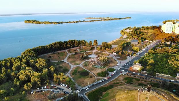 CHERKASY, UKRAINE - AUGUST 24, 2018 : aerial video with drone, the celebration of Independence Day, many people walk in park on banks of the Dnieper River, hot summer day. High quality photo