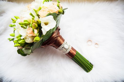 bridal bouquet and rings on a white background