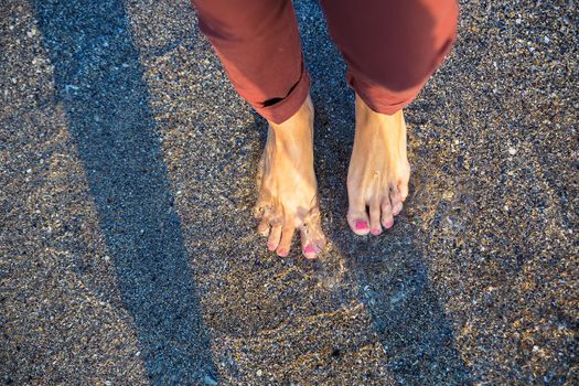 Woman standing on the beach with wave sea, Top view.