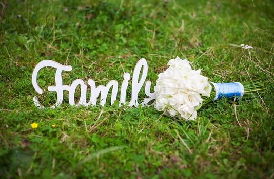 family wooden letters and a beautiful wedding bouquet