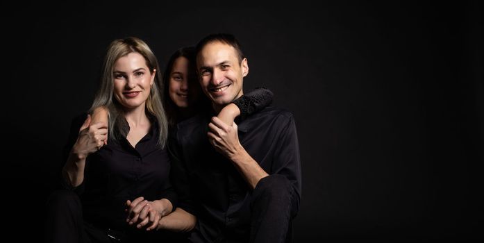 Family portrait on black background.