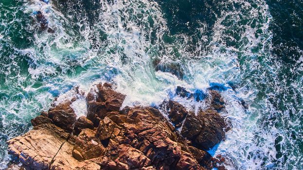 Image of Rocky coasts of Maine aerial from above looking at waves crashing