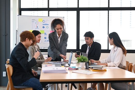 Group of start up business people discussing over new business project and planning marketing strategy at modern office.