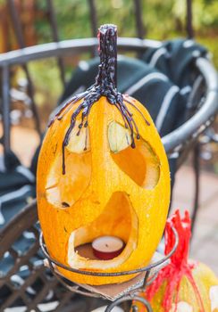 pumpkin with face and candle for Halloween.