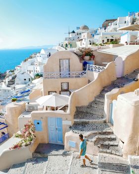 Santorini Greece, men on luxury vacation Oia Santorini Island Greece visit the white village with beautiful building overlooking the caldera ocean