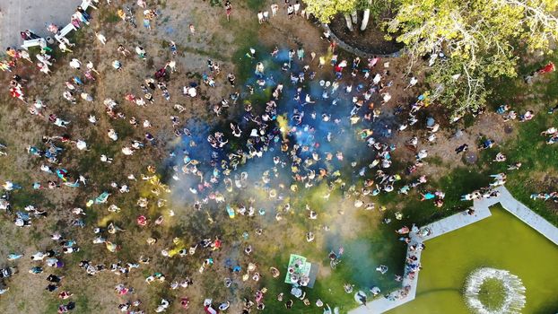 CHERKASY, UKRAINE - AUGUST 24, 2018 : aerial video with drone, Independence Day celebration, festival of colors, people throw up yellow and blue paints in sky, national flag. High quality photo