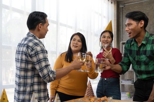 Group of asian friends eating pizza during party at home. Happy asian people having fun together, eating pizza food and beer together with happiness and fun