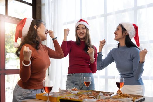 Group of young asian office girl friends having fun, talking and eating pizza together with happiness and fun. Lifestyle Concept.