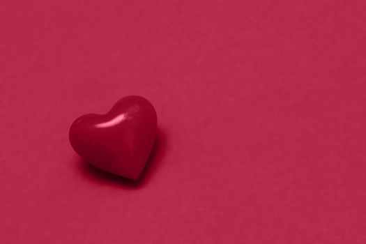 Valentines day red heart on same color background. Monochromatic vivid color. Valentine's day concept. Close up, copy space