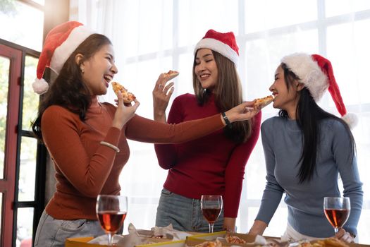 Group of young asian office girl friends having fun, talking and eating pizza together with happiness and fun. Lifestyle Concept.