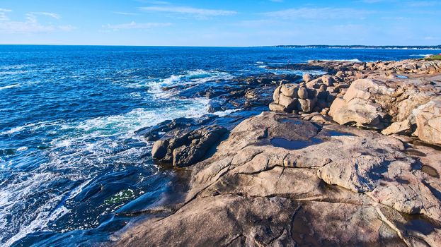 Image of Rocky coasts of Maine with ocean waves crashing into cliffs
