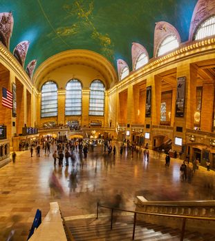 Image of People fill iconic Grand Central Station wide panorama by stairs in New York City