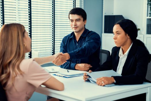 A young female asian candidate tries to impress her interviewer by being competent. International company, multicultural environment in workplace.