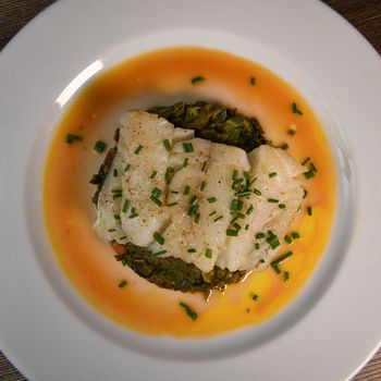 RECIPE FOR CHARD, TOMATO, ONION AND LEMON FONDUE WITH COD FILLET AND CHIVES. High quality photo