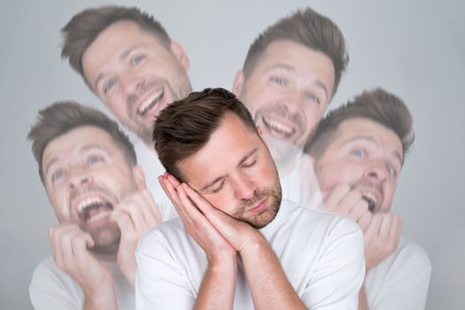 Young caucasian man sleeping tired dreaming and posing with hands together while smiling with closed eyes. 