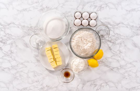 Flat lay. Step by step. Ingredients in glass mixing bowls to prepare lemon bundt cake.
