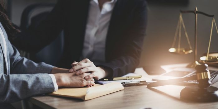 Justice and attorney concept. Lawyer meeting and consoling solution to his client provide legal advice and trust commitment strain serious for problem..