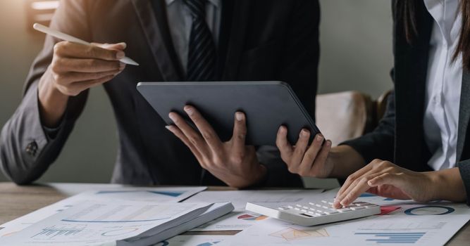 Asian business adviser meeting to analyze and discuss the situation on the financial report in the meeting room.Investment Consultant, Financial advisor and accounting concept..