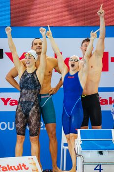 MELBOURNE, AUSTRALIA - DECEMBER 16: France team of Maxime GROUSSET, Florent MANAUDOU, Beryl GASTALDELLO and Melanie HENIQUE celebrate winning the Mixed 4x50m Freestyle relay at the 2022 FINA World Short Course Swimming Championships at Melbourne Sports and Aquatic Centre on December 16, 2022 in Melbourne, Australia