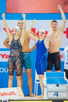 MELBOURNE, AUSTRALIA - DECEMBER 16: France team of Maxime GROUSSET, Florent MANAUDOU, Beryl GASTALDELLO and Melanie HENIQUE celebrate winning the Mixed 4x50m Freestyle relay at the 2022 FINA World Short Course Swimming Championships at Melbourne Sports and Aquatic Centre on December 16, 2022 in Melbourne, Australia