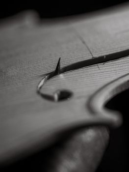 violinmaker cutting and sawing golden period cremonese violin model fholes with a blade with precision