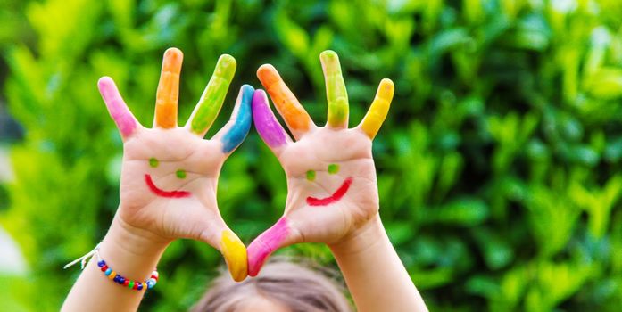 Children's hands in the colors of summer. Selective focus.arts