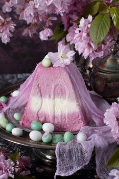 sweet curd orthodox easter on the background of purple sakura flowers, traditional food, sweet home, High quality photo