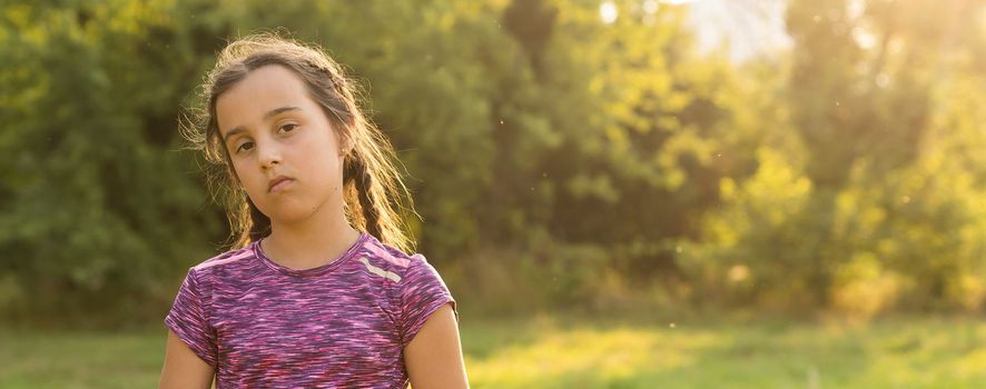 Cute little girl on the meadow in spring day.