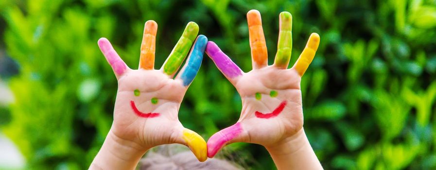 Children's hands in the colors of summer. Selective focus.arts