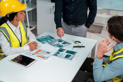 Engineers and competent employer discussing plans and blueprints together with tablet in the office. Concept of team contribution of ideas for engineering project.