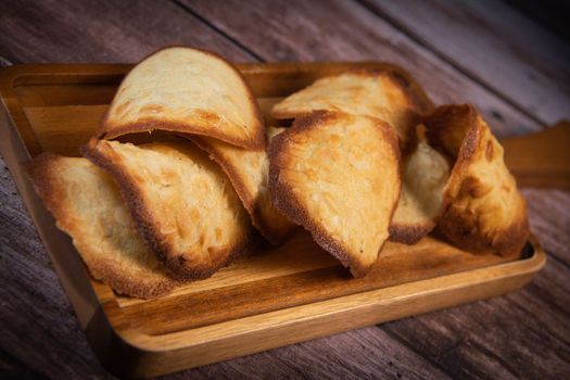 French delicacy pastry tuile with almond on wood background, High quality photo