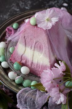 sweet curd orthodox easter on the background of purple sakura flowers, traditional food, sweet home, High quality photo