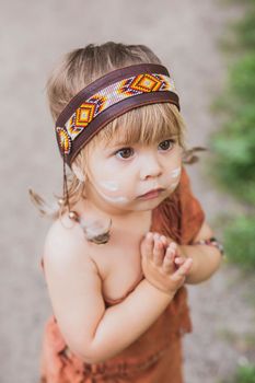 Cute baby dressed in traditional native americanс costume