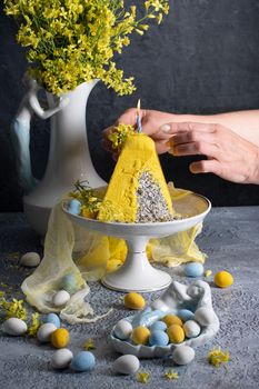 Traditional Easter Orthodox curd cake with yellow flowers on a grey table, High quality photo