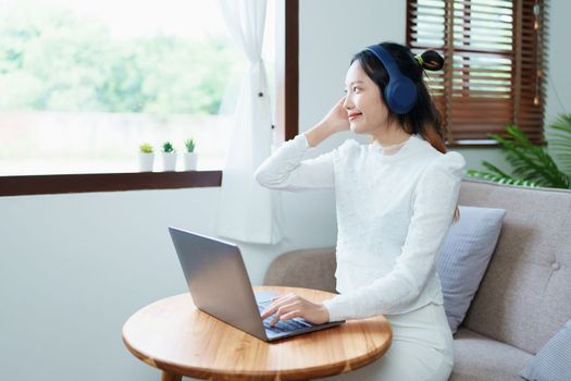 Portrait of a beautiful Asian teenage girl using a computer.