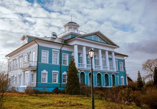 An old beautiful mansion with a wooden veranda, built in the 19th century. A big old house with a garden in Cherepovets, Russia. The building houses a museum 