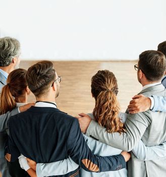 group of business people team standing toghether and holding each other in the office