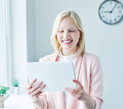 portrait of a young business woman holding a tablet computer in the office